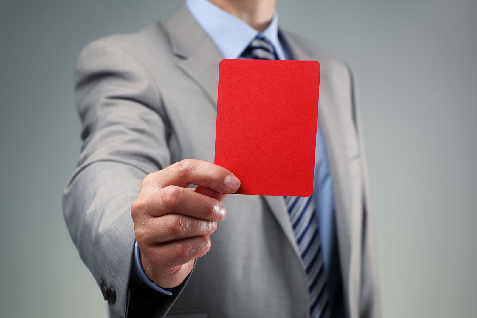 Man in suit holding a red card