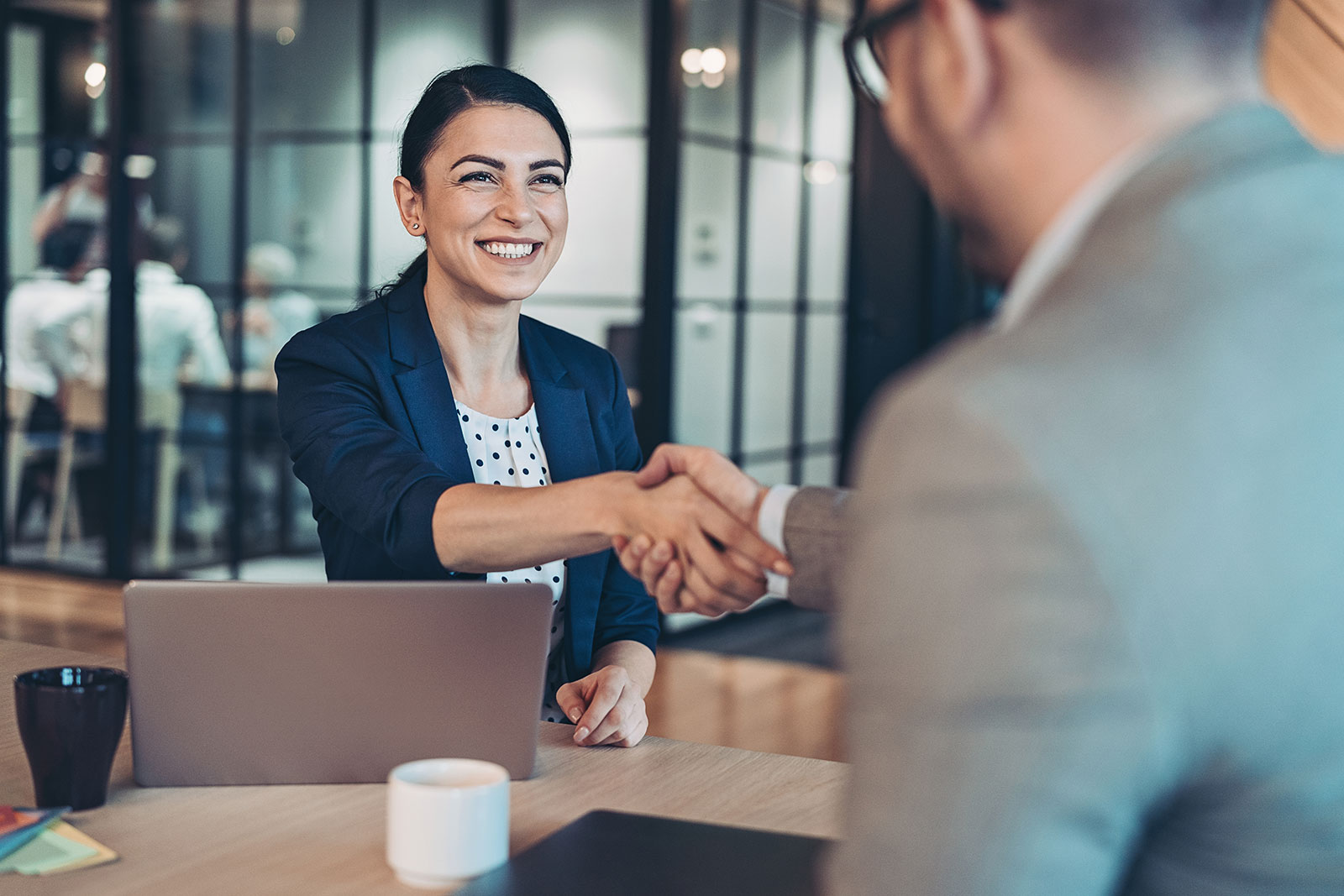 Businesswoman shaking hands with businessman