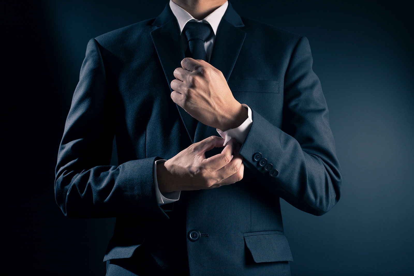 Man in suit adjusting his suit